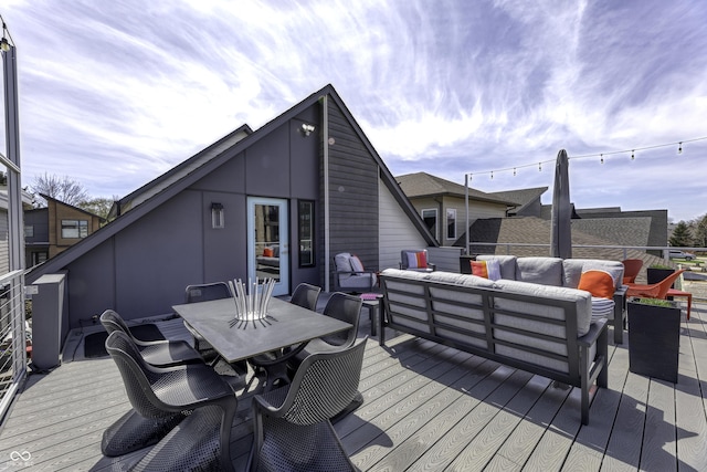wooden deck with outdoor dining area and an outdoor living space