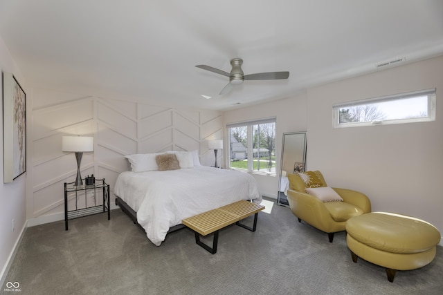 carpeted bedroom with baseboards, a ceiling fan, and visible vents