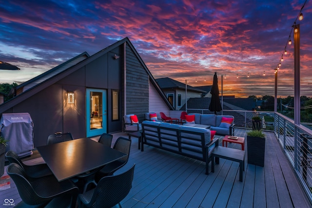 wooden deck featuring outdoor dining area, grilling area, and an outdoor hangout area