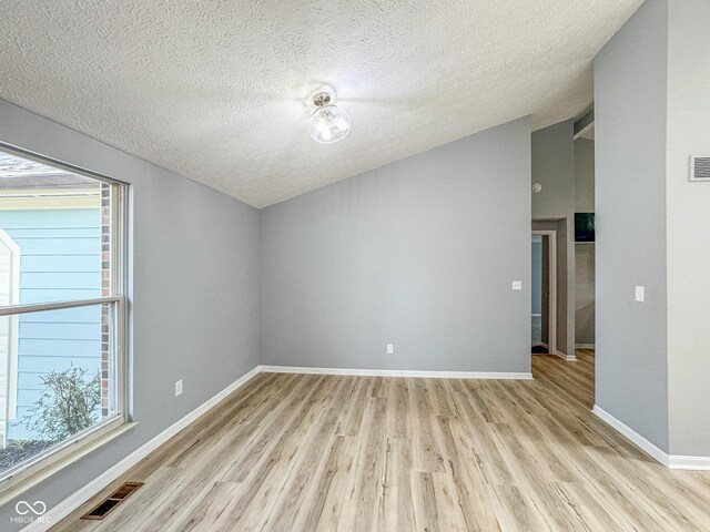 9362 Helmsdale Dr, Indianapolis, IN 46256 - unfurnished room featuring a textured ceiling, visible vents, and light wood-type flooring