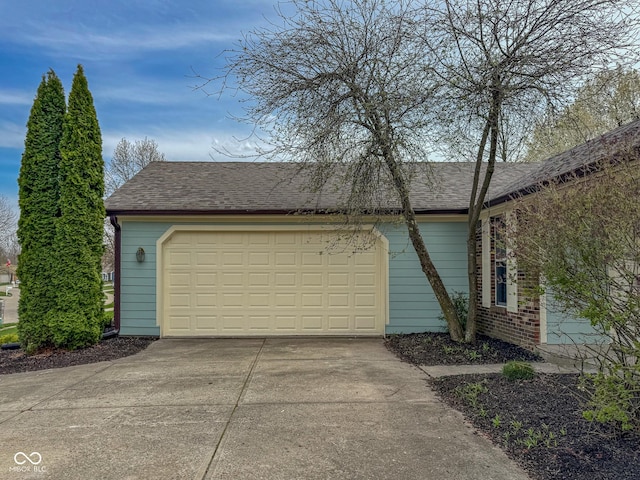 9362 Helmsdale Dr, Indianapolis, IN 46256 - view of side of property featuring concrete driveway, an attached garage, and roof with shingles
