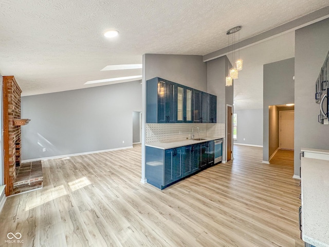 9362 Helmsdale Dr, Indianapolis, IN 46256 - unfurnished living room with a sink, a textured ceiling, a chandelier, light wood finished floors, and baseboards
