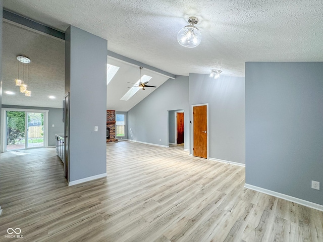 9362 Helmsdale Dr, Indianapolis, IN 46256 - interior space featuring a healthy amount of sunlight, vaulted ceiling with skylight, a textured ceiling, and light wood-style floors