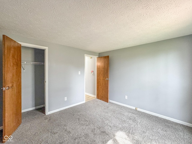 9362 Helmsdale Dr, Indianapolis, IN 46256 - unfurnished bedroom with a textured ceiling, baseboards, carpet, and a closet