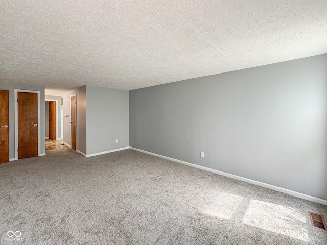 9362 Helmsdale Dr, Indianapolis, IN 46256 - unfurnished room featuring baseboards, visible vents, carpet, and a textured ceiling