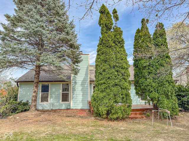 9362 Helmsdale Dr, Indianapolis, IN 46256 - exterior space featuring a front lawn, roof with shingles, and a chimney