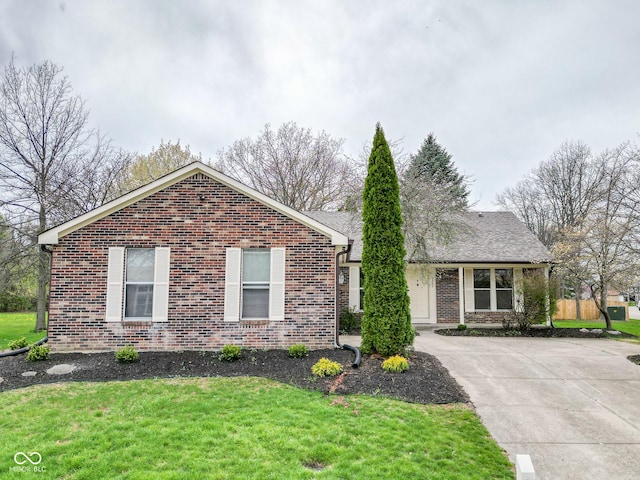9362 Helmsdale Dr, Indianapolis, IN 46256 - ranch-style home with brick siding, driveway, and a front lawn