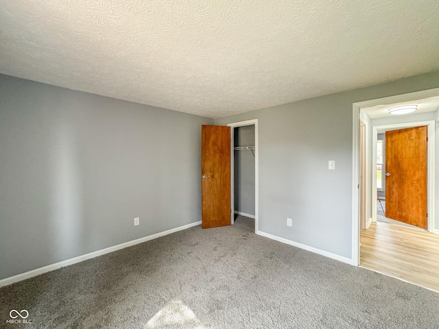 9362 Helmsdale Dr, Indianapolis, IN 46256 - unfurnished bedroom with a textured ceiling, carpet floors, a closet, and baseboards
