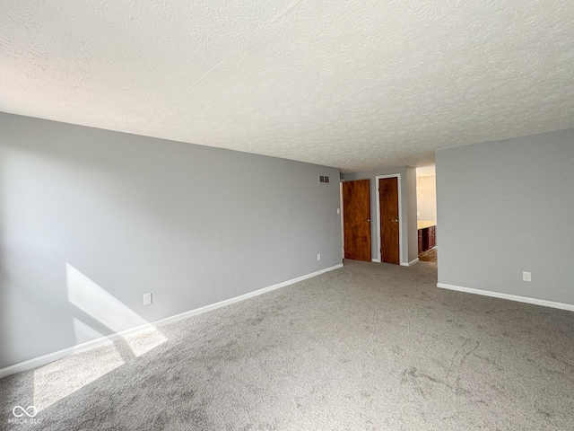 9362 Helmsdale Dr, Indianapolis, IN 46256 - carpeted empty room with a textured ceiling, baseboards, and visible vents
