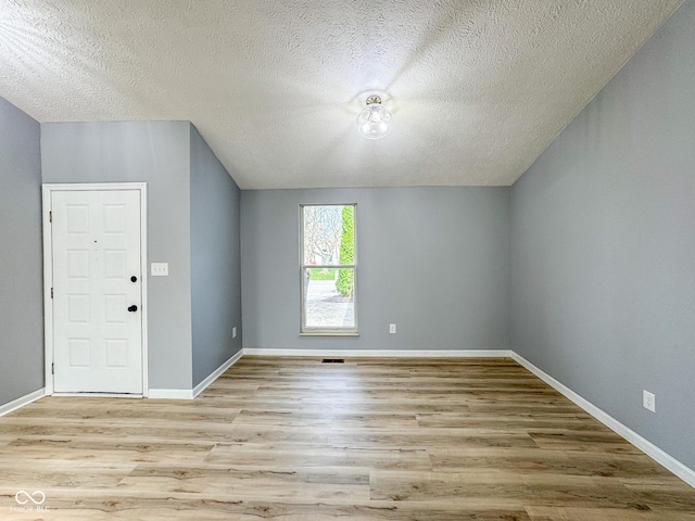 9362 Helmsdale Dr, Indianapolis, IN 46256 - additional living space featuring wood finished floors, a textured ceiling, and baseboards