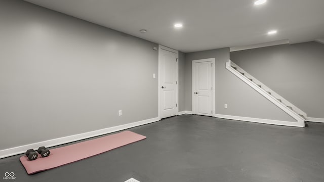 finished basement featuring recessed lighting, baseboards, and stairway