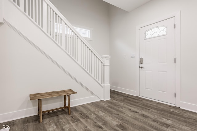 foyer entrance with stairway, baseboards, and dark wood-style floors