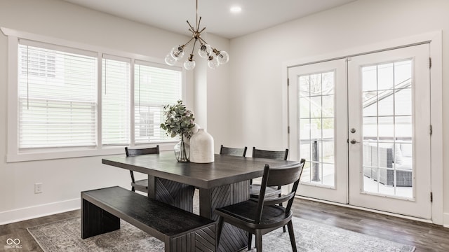 dining space featuring an inviting chandelier, baseboards, dark wood-style floors, and french doors