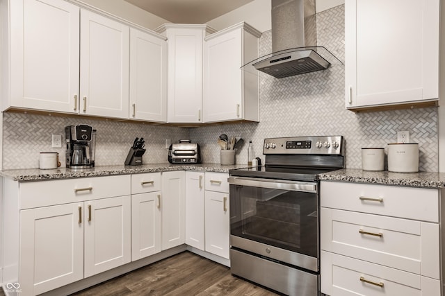 kitchen featuring wall chimney range hood, stainless steel range with electric cooktop, dark wood-style floors, and backsplash