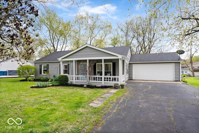 single story home with a porch, aphalt driveway, a front yard, and a garage