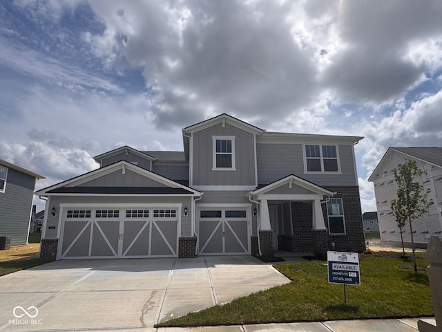 craftsman house with brick siding, board and batten siding, concrete driveway, and an attached garage