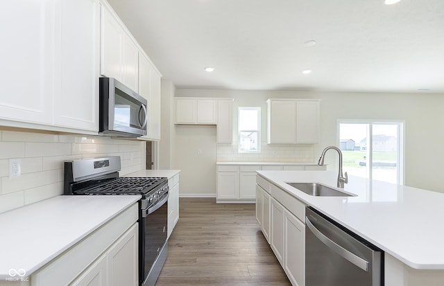 827 Allandale Ave, Westfield, IN 46074 - kitchen with appliances with stainless steel finishes, a sink, decorative backsplash, recessed lighting, and light wood-style floors