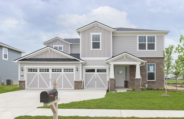 827 Allandale Ave, Westfield, IN 46074 - view of front facade featuring brick siding, driveway, a front yard, and board and batten siding