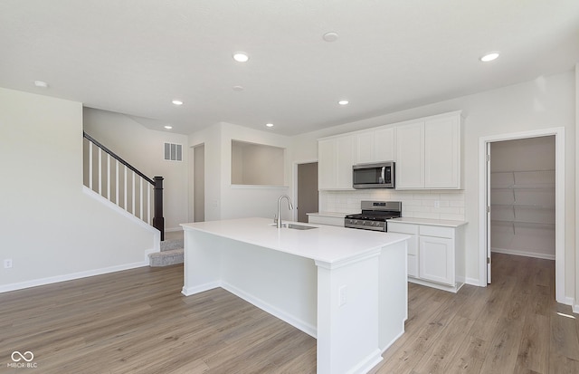 827 Allandale Ave, Westfield, IN 46074 - kitchen featuring stainless steel appliances, a sink, an island with sink, light wood-style flooring, and recessed lighting
