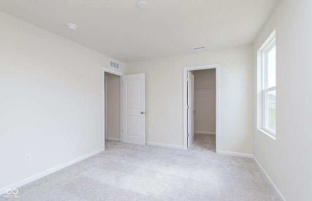 827 Allandale Ave, Westfield, IN 46074 - unfurnished bedroom featuring carpet flooring, a walk in closet, baseboards, and a closet