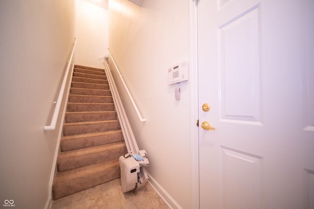 staircase featuring baseboards