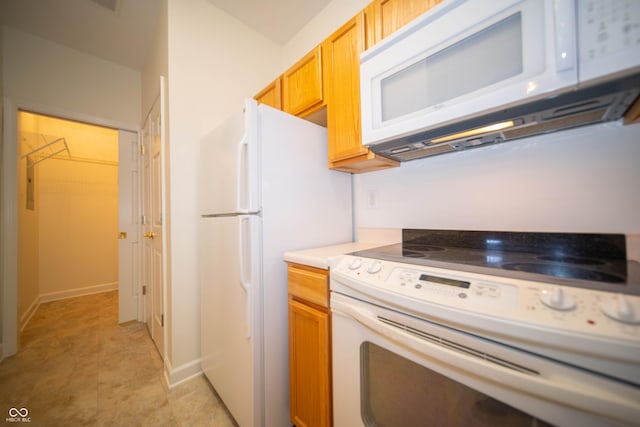 kitchen with white appliances and baseboards