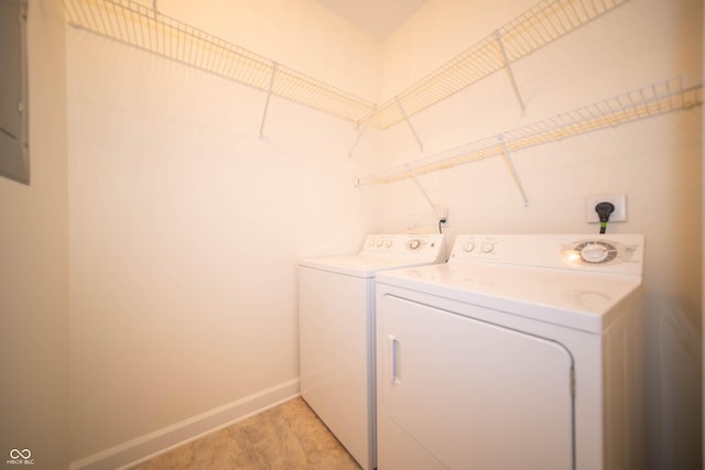 laundry area featuring laundry area, baseboards, and washing machine and clothes dryer
