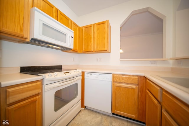 kitchen with light countertops and white appliances