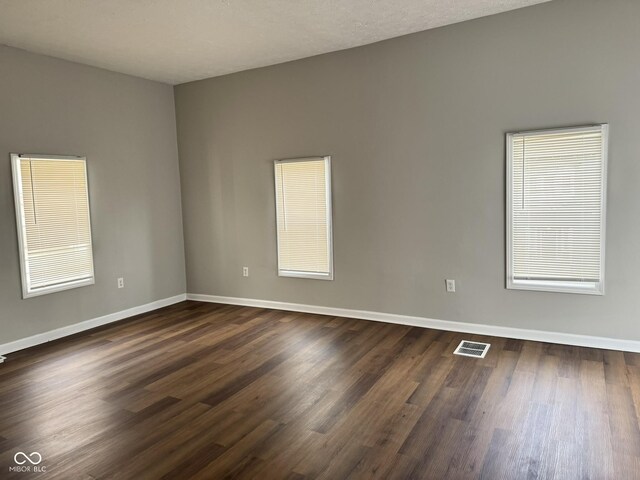 3502 N Illinois St, Indianapolis, IN 46208 - spare room featuring baseboards, dark wood-style floors, and visible vents