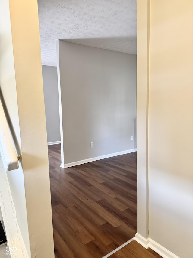 3502 N Illinois St, Indianapolis, IN 46208 - empty room featuring baseboards, a textured ceiling, and dark wood-style floors