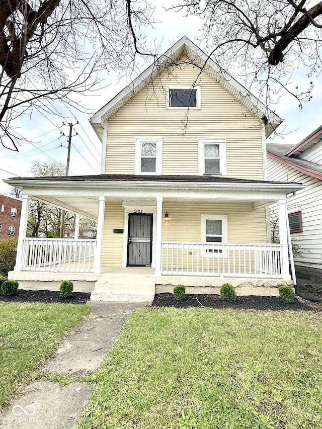 3502 N Illinois St, Indianapolis, IN 46208 - farmhouse with a front yard and covered porch
