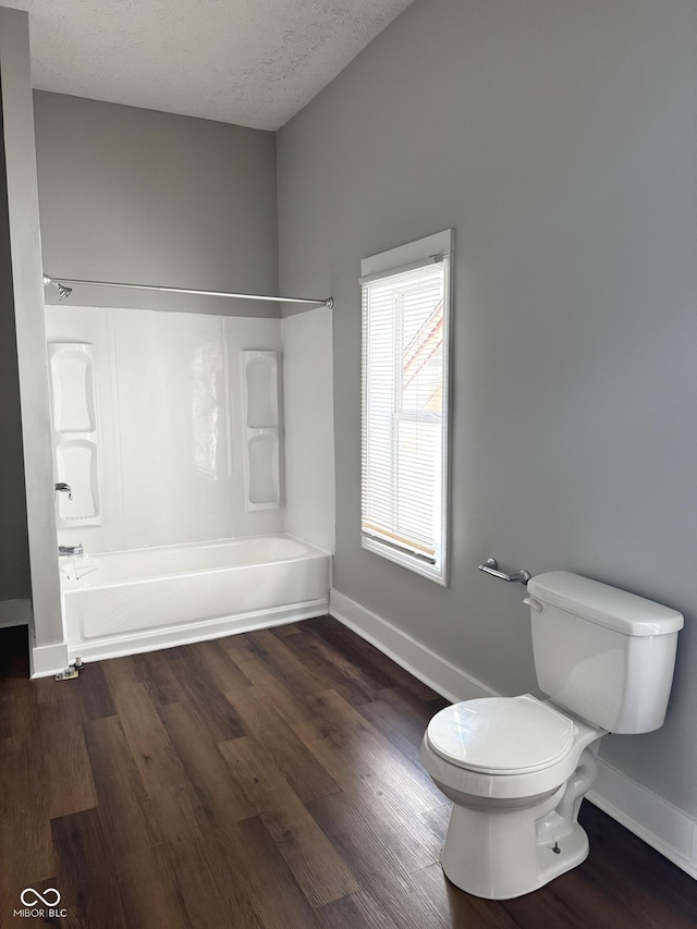 3502 N Illinois St, Indianapolis, IN 46208 - bathroom with bathtub / shower combination, baseboards, toilet, and wood finished floors