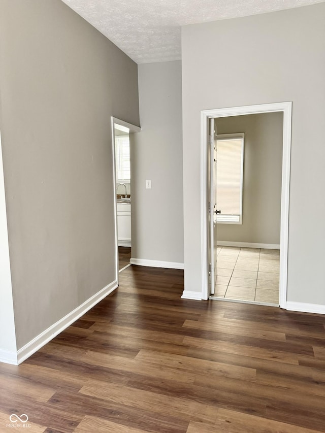 3502 N Illinois St, Indianapolis, IN 46208 - interior space featuring a textured ceiling, wood finished floors, a sink, and baseboards