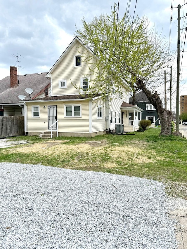 3502 N Illinois St, Indianapolis, IN 46208 - view of front of home featuring fence, central AC unit, and a front lawn