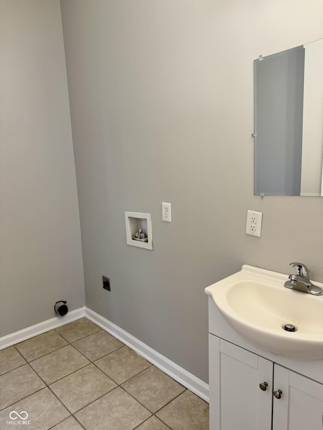 3502 N Illinois St, Indianapolis, IN 46208 - clothes washing area with light tile patterned floors, baseboards, a sink, hookup for an electric dryer, and hookup for a washing machine