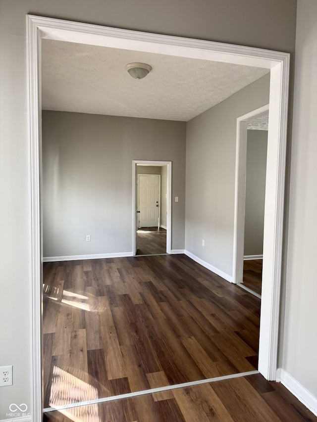3502 N Illinois St, Indianapolis, IN 46208 - unfurnished room featuring baseboards, a textured ceiling, and dark wood finished floors