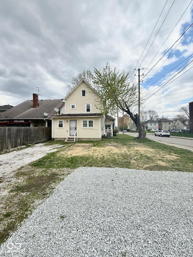 3502 N Illinois St, Indianapolis, IN 46208 - rear view of house featuring a yard, entry steps, and fence