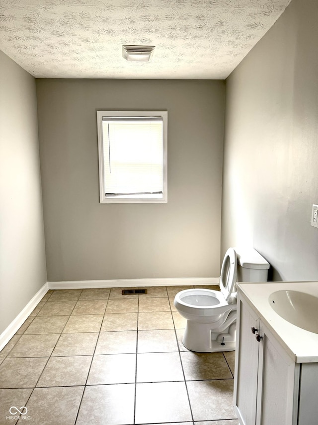3502 N Illinois St, Indianapolis, IN 46208 - half bathroom featuring a textured ceiling, vanity, visible vents, toilet, and tile patterned floors