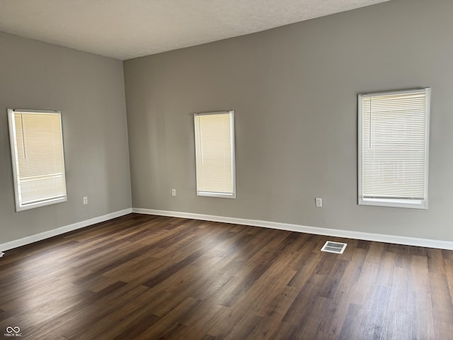 3502 N Illinois St, Indianapolis, IN 46208 - unfurnished room featuring dark wood-style floors, baseboards, and visible vents