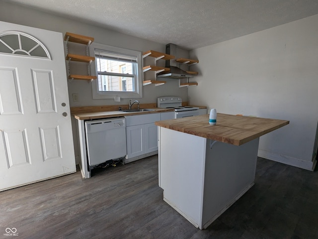 kitchen featuring white appliances, open shelves, a kitchen island, a sink, and butcher block countertops