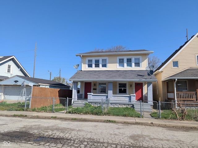 view of front of home featuring roof with shingles, a fenced front yard, a gate, and covered porch