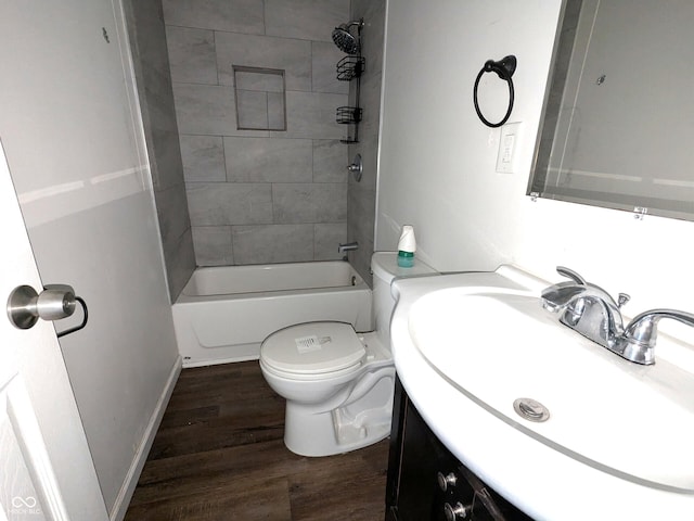 full bath with  shower combination, vanity, toilet, and wood finished floors