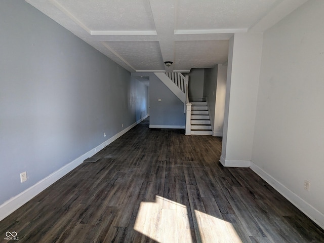 unfurnished living room with baseboards, stairway, and wood finished floors