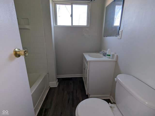 bathroom featuring vanity, baseboards, toilet, and wood finished floors