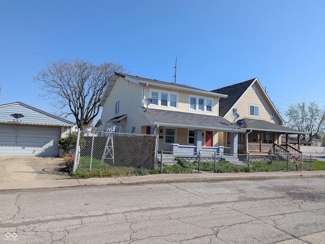 408 E Beecher St, Indianapolis, IN 46225 - view of front of home with a porch, a fenced front yard, an outbuilding, a garage, and driveway