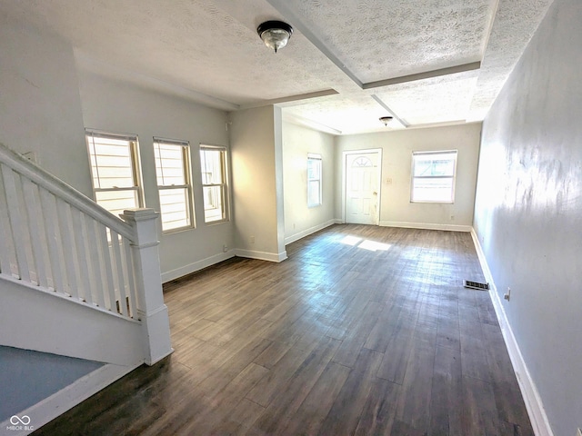408 E Beecher St, Indianapolis, IN 46225 - unfurnished living room featuring wood finished floors, baseboards, stairway, and a textured ceiling