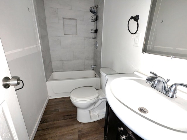 408 E Beecher St, Indianapolis, IN 46225 - bathroom featuring vanity, wood finished floors, toilet, and tub / shower combination