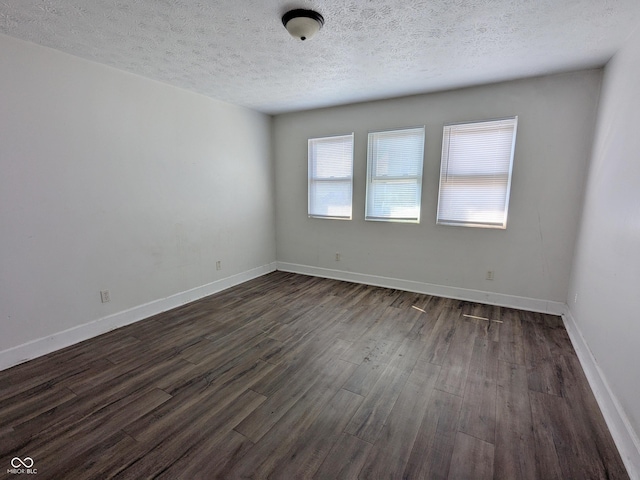408 E Beecher St, Indianapolis, IN 46225 - spare room featuring dark wood finished floors, a textured ceiling, and baseboards