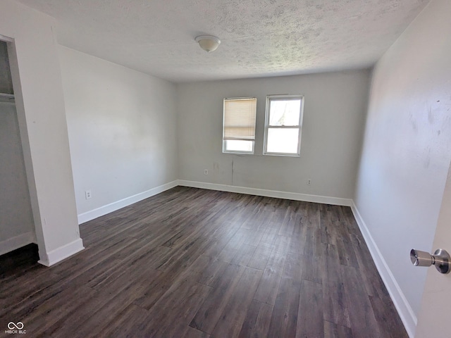 408 E Beecher St, Indianapolis, IN 46225 - unfurnished bedroom with a textured ceiling, dark wood-style flooring, and baseboards