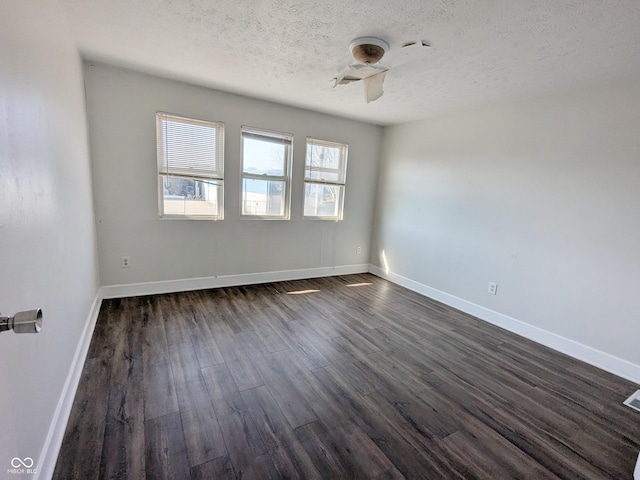 408 E Beecher St, Indianapolis, IN 46225 - spare room featuring a textured ceiling, dark wood-style floors, a ceiling fan, and baseboards